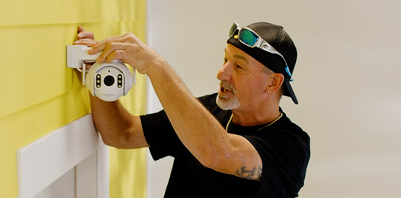 Influencer placing a security camera outside